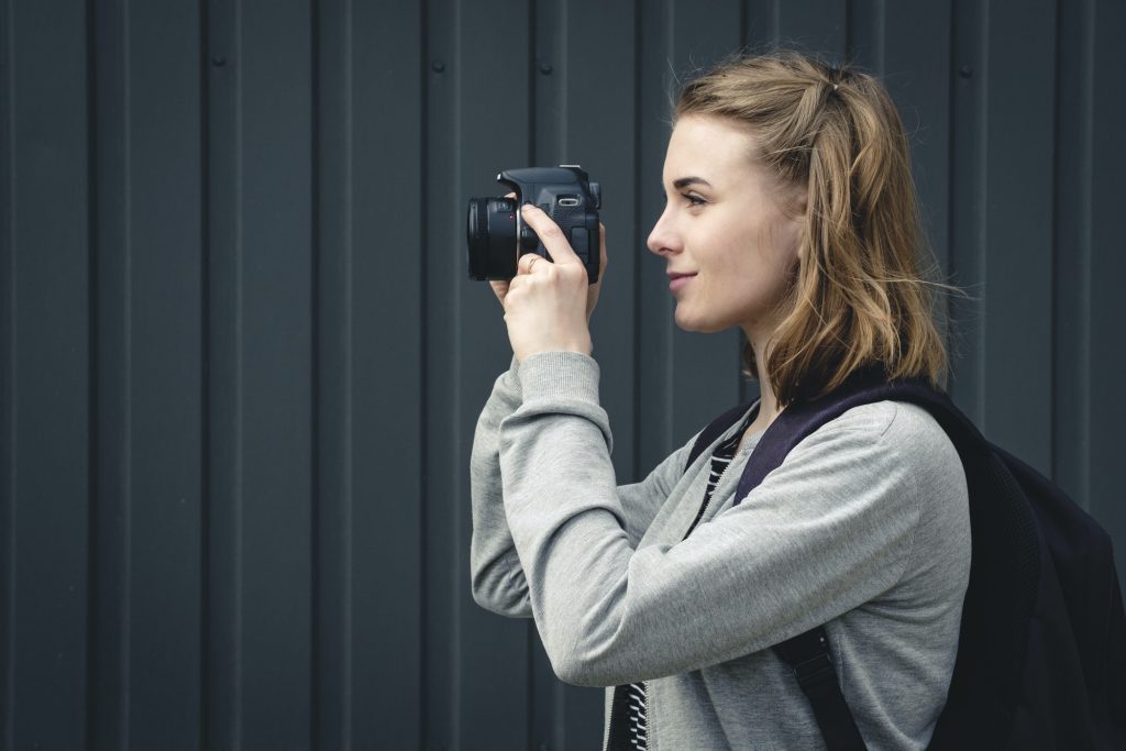 Young woman photographer lining up an image