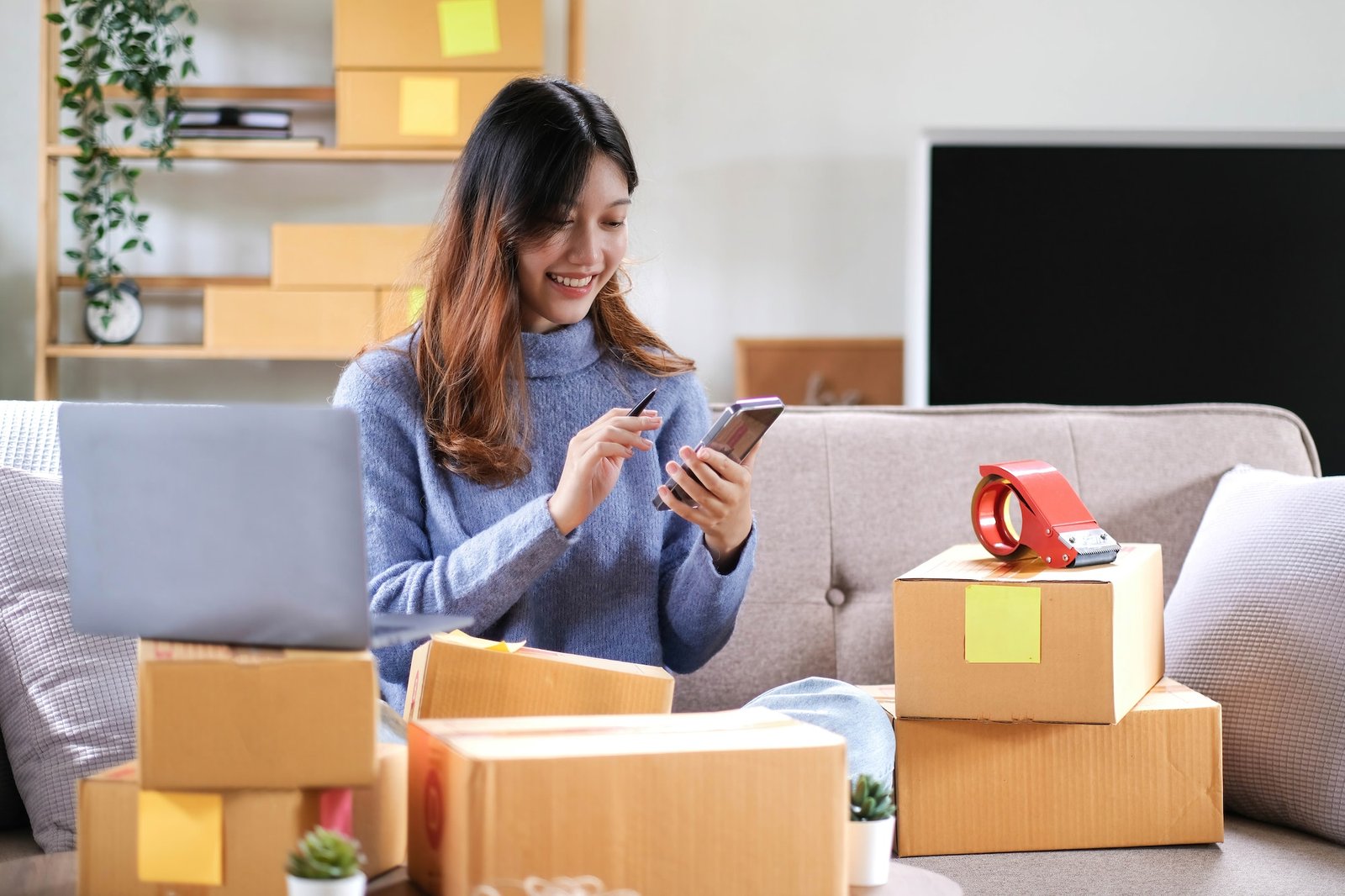 Portrait of a Small Business Startup, SME Owner, Female Entrepreneur work on parcel boxes Receipts